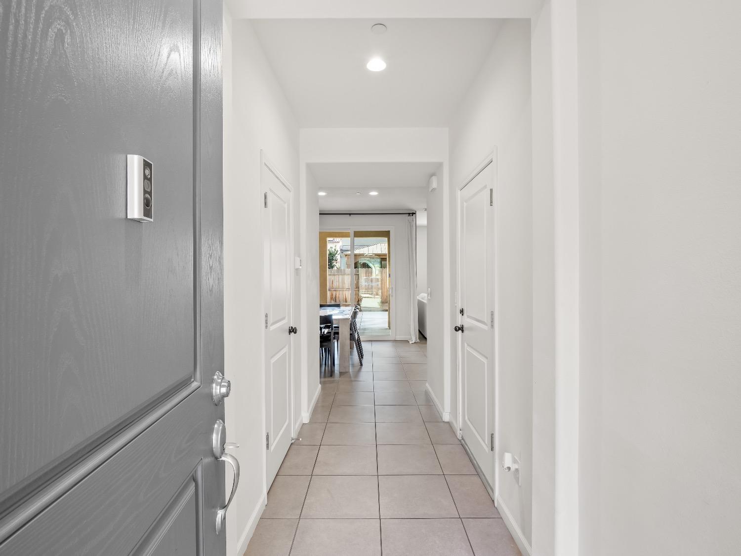 867 Fir Street Madera, CA 93636 - Photo 3 of 39 a hallway with white doors and chandelier