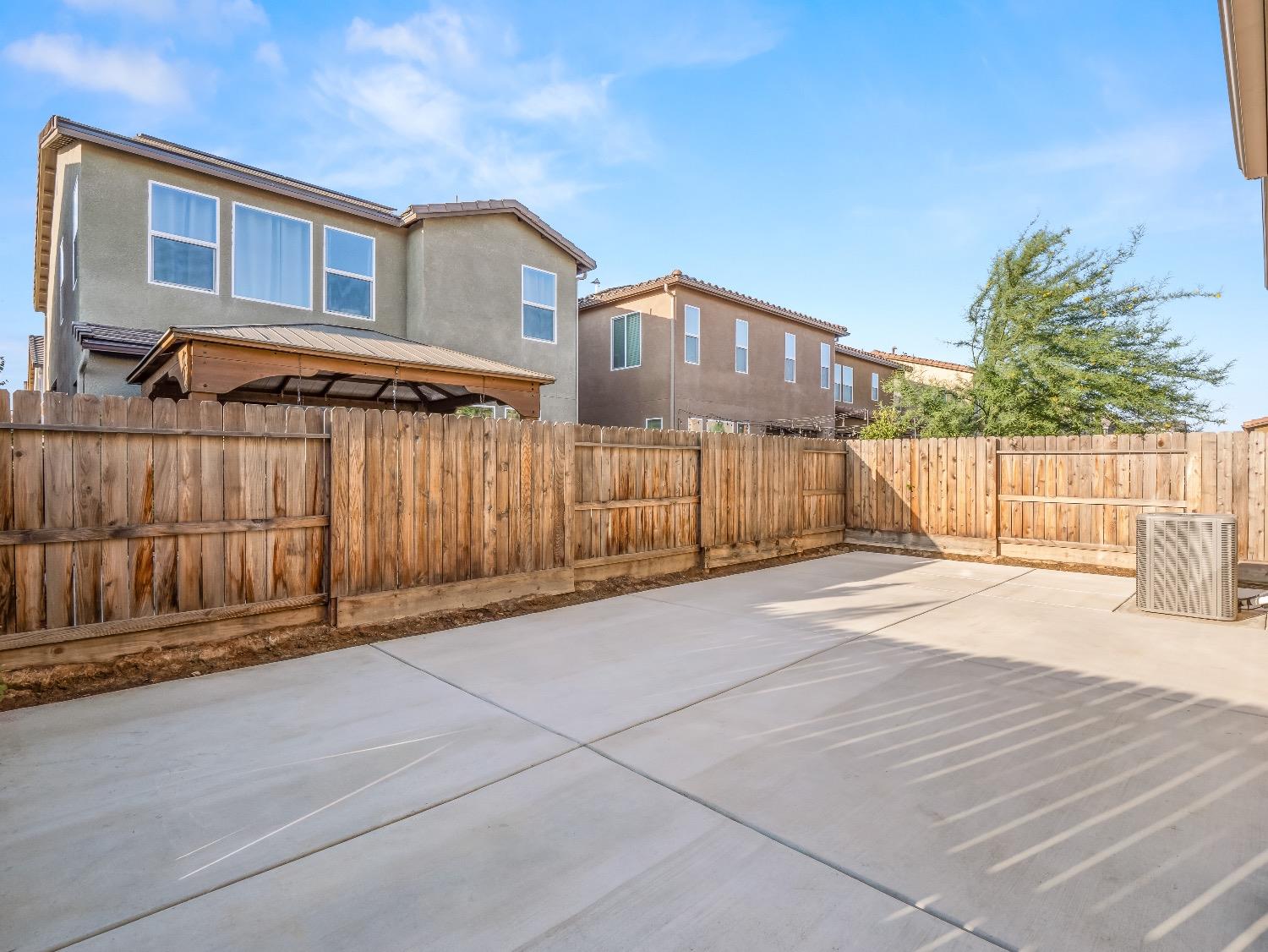 867 Fir Street Madera, CA 93636 - Photo 31 of 39 a front view of a house with a garage