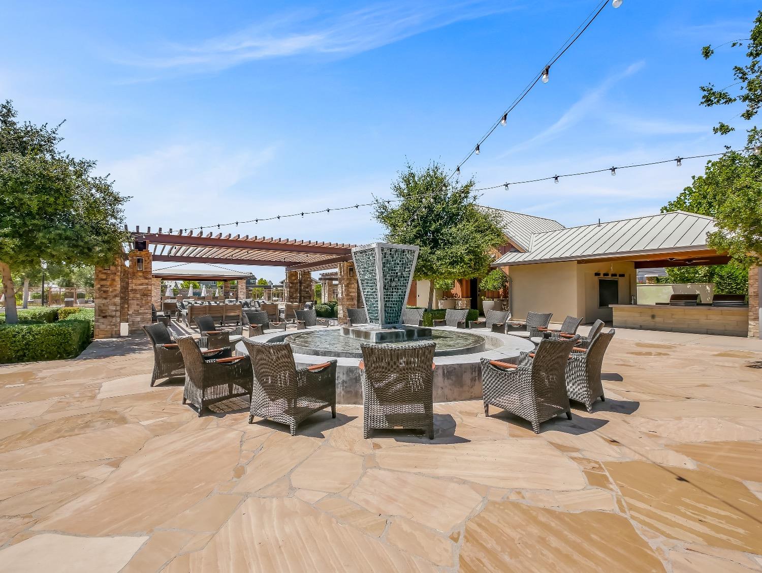 867 Fir Street Madera, CA 93636 - Photo 37 of 39 a view of a patio with table and chairs potted plants and a large tree