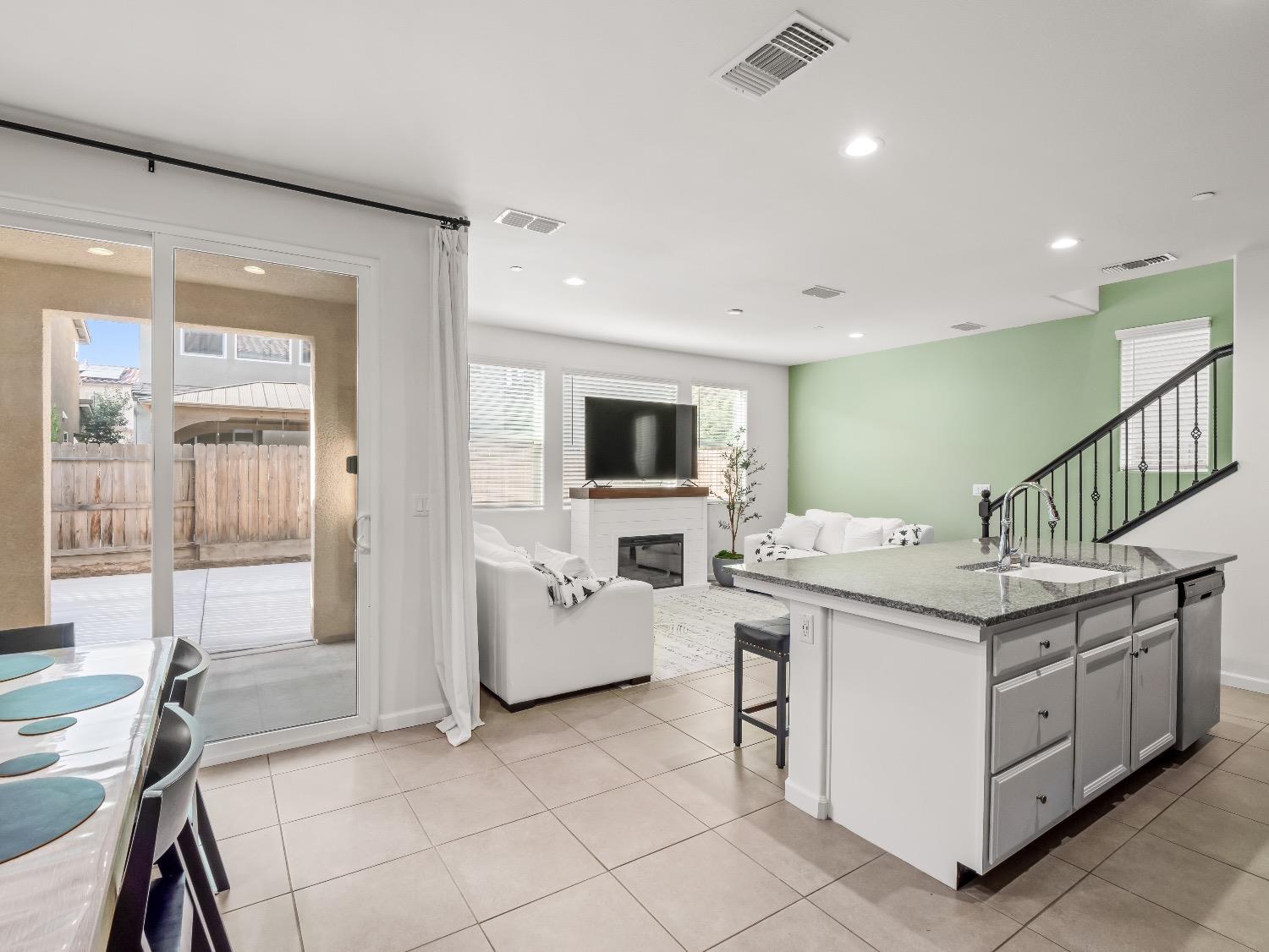 867 Fir Street Madera, CA 93636 - Photo 4 of 39 a kitchen that has a lot of cabinets in it and a wooden floor