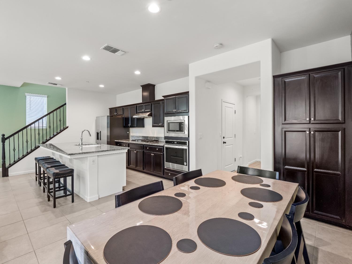 867 Fir Street Madera, CA 93636 - Photo 6 of 39 a kitchen with a sink stove and refrigerator