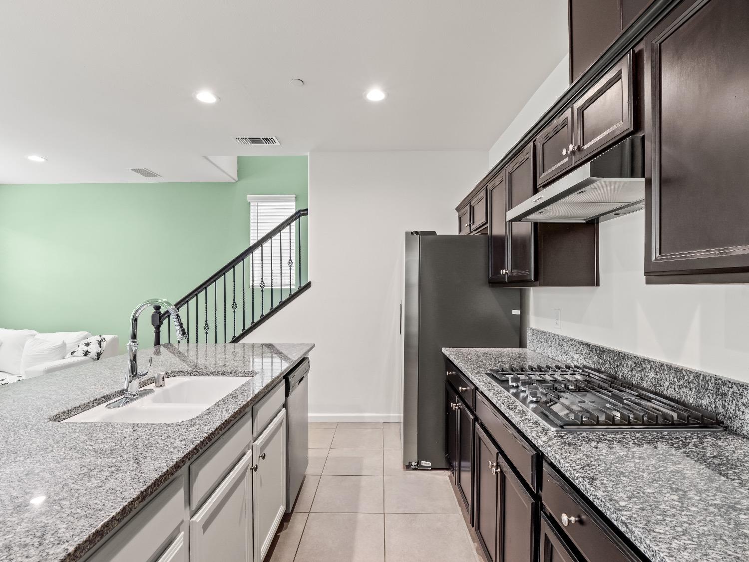 867 Fir Street Madera, CA 93636 - Photo 8 of 39 a kitchen with sink stove and cabinets