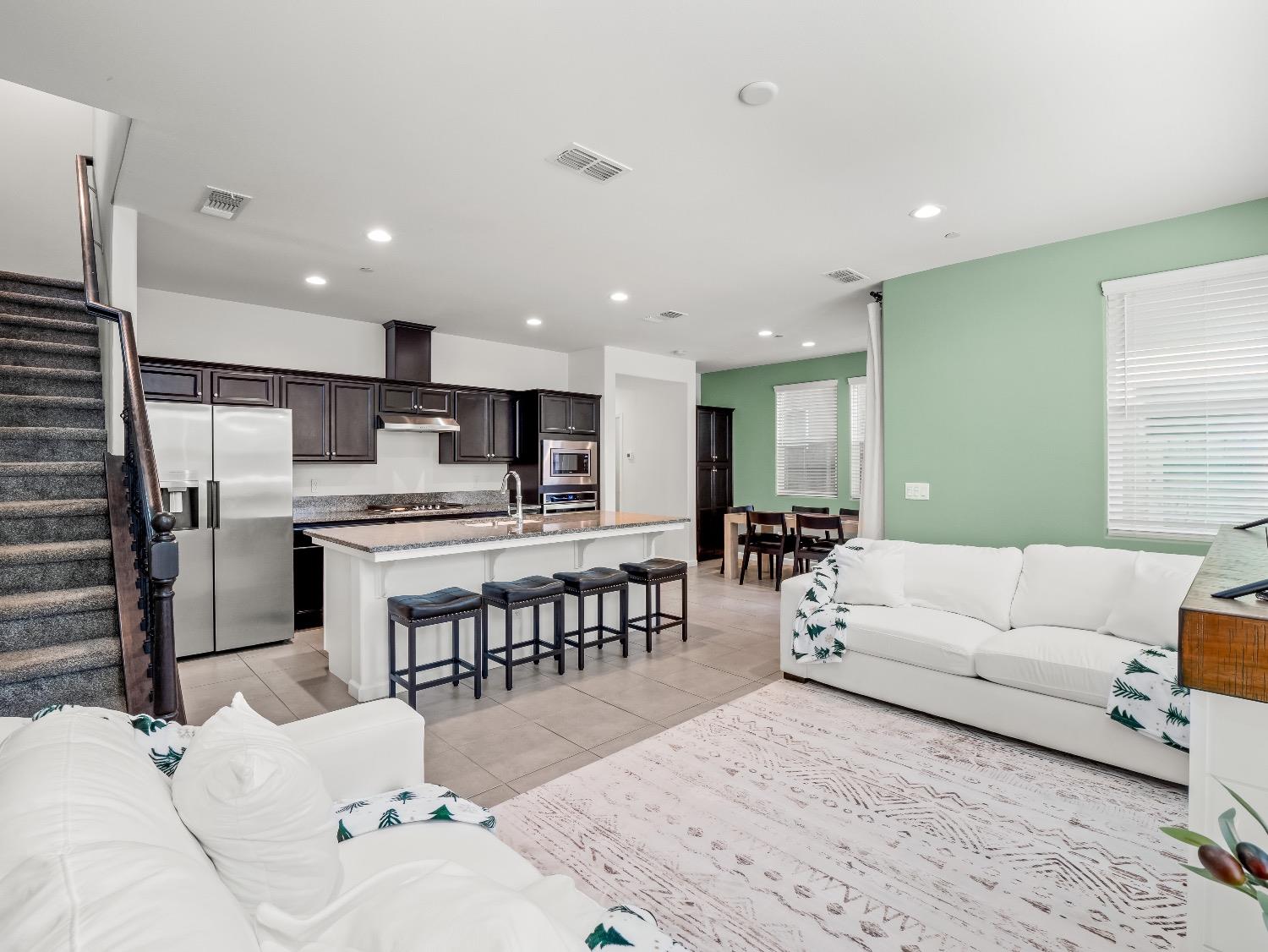 867 Fir Street Madera, CA 93636 - Photo 10 of 39 a living room with stainless steel appliances kitchen island granite countertop a couch and a view living room