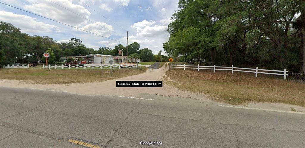 Tbd Southeast 71st Terrace Road Belleview, FL 34420 - Photo 3 of 4 a view of a swimming pool with an outdoor space and seating area