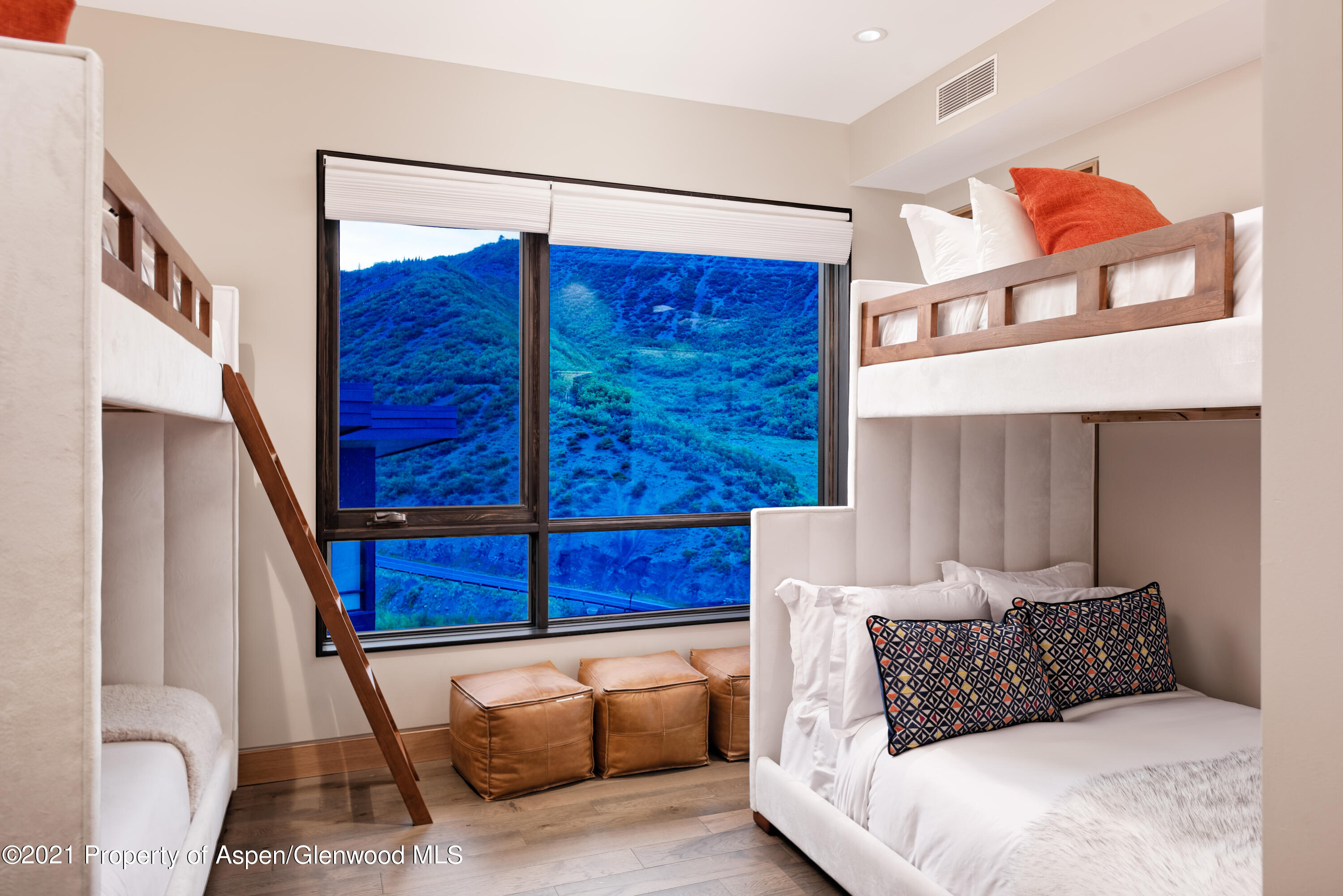 77 Wood Road, Unit 801E Snowmass Village, CO 81615 - Photo 11 of 30 a bedroom with a bed and wooden floor