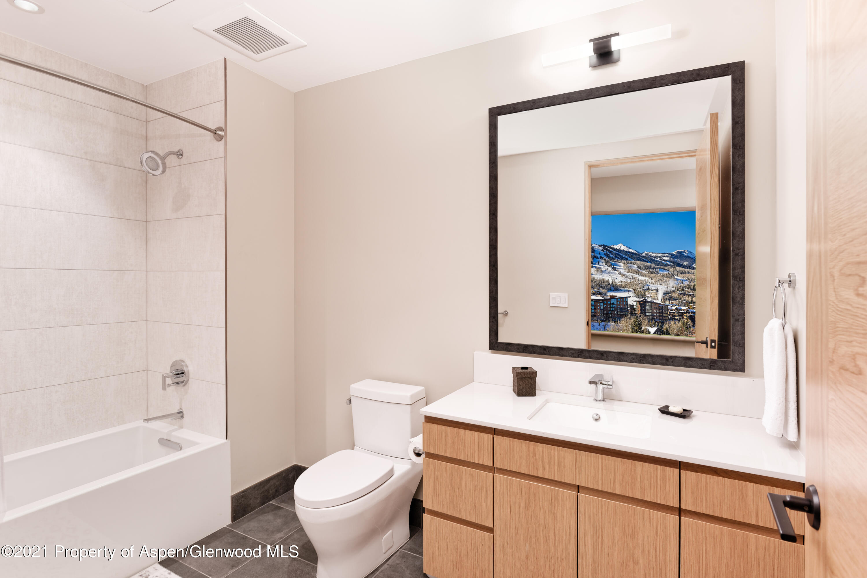 77 Wood Road, Unit 801E Snowmass Village, CO 81615 - Photo 13 of 30 a bathroom with a toilet sink and mirror