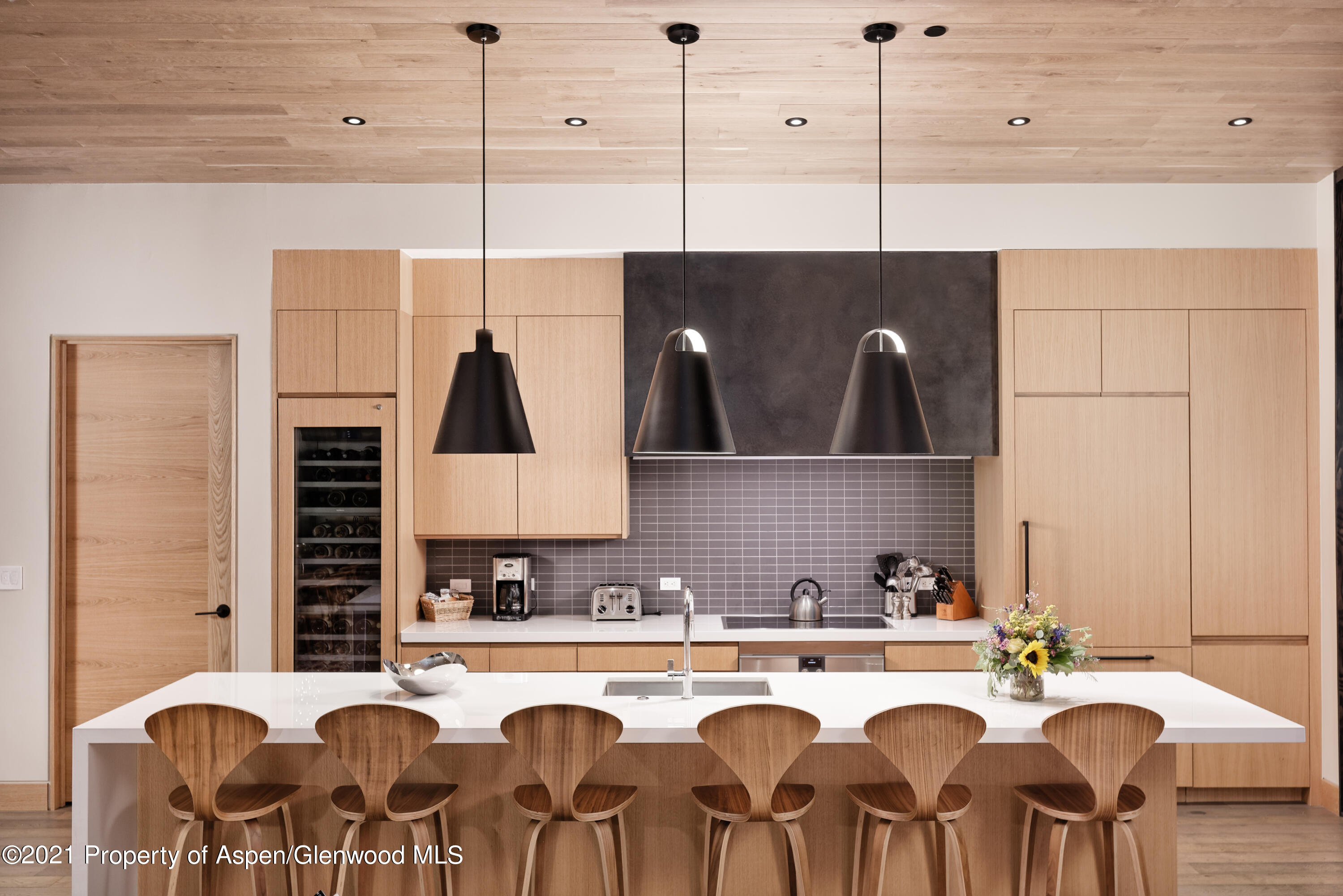 77 Wood Road, Unit 801E Snowmass Village, CO 81615 - Photo 6 of 30 a kitchen with a dining table chairs and white appliances
