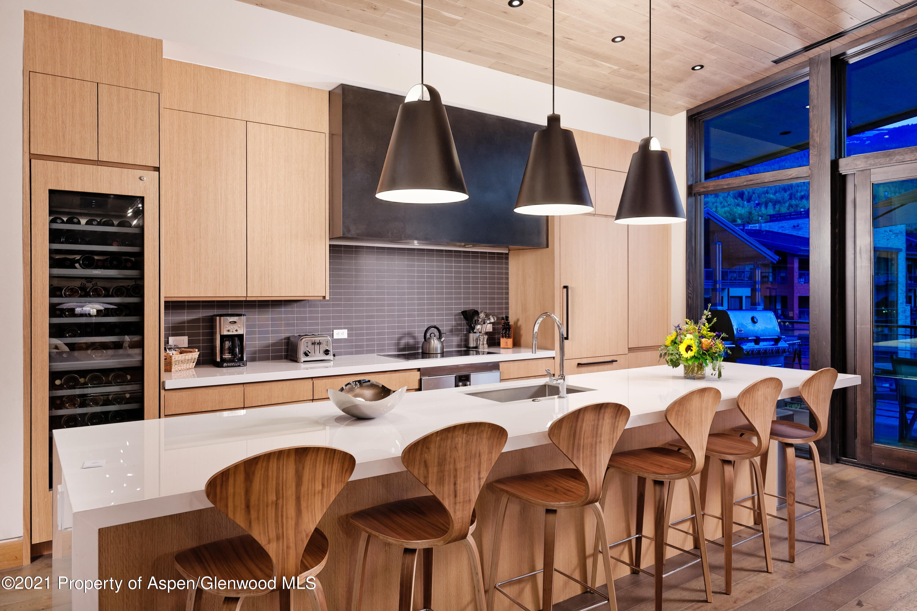 77 Wood Road, Unit 801E Snowmass Village, CO 81615 - Photo 7 of 30 a kitchen with stainless steel appliances granite countertop a sink a stove and chairs