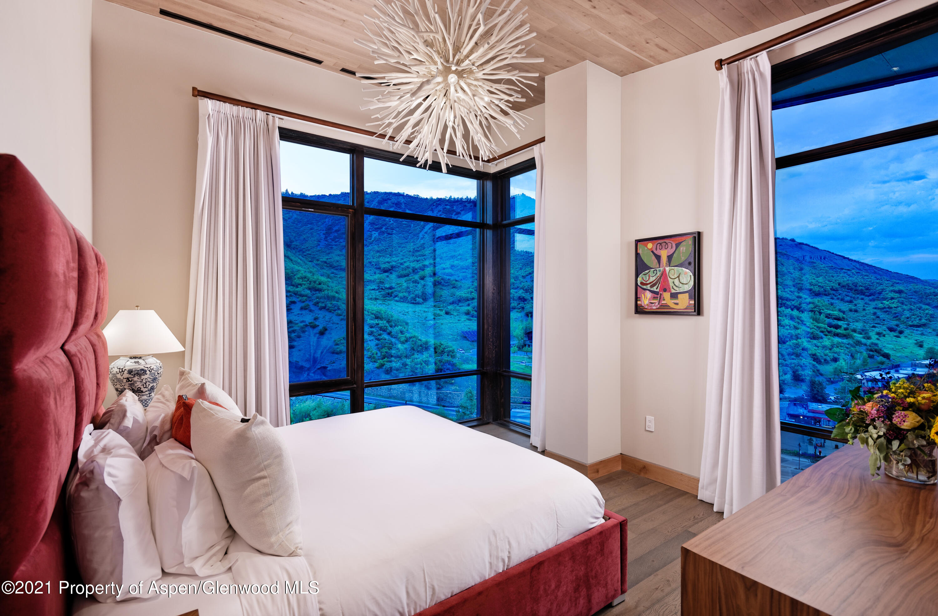 77 Wood Road, Unit 801E Snowmass Village, CO 81615 - Photo 8 of 30 a bed sitting in a bedroom next to a window