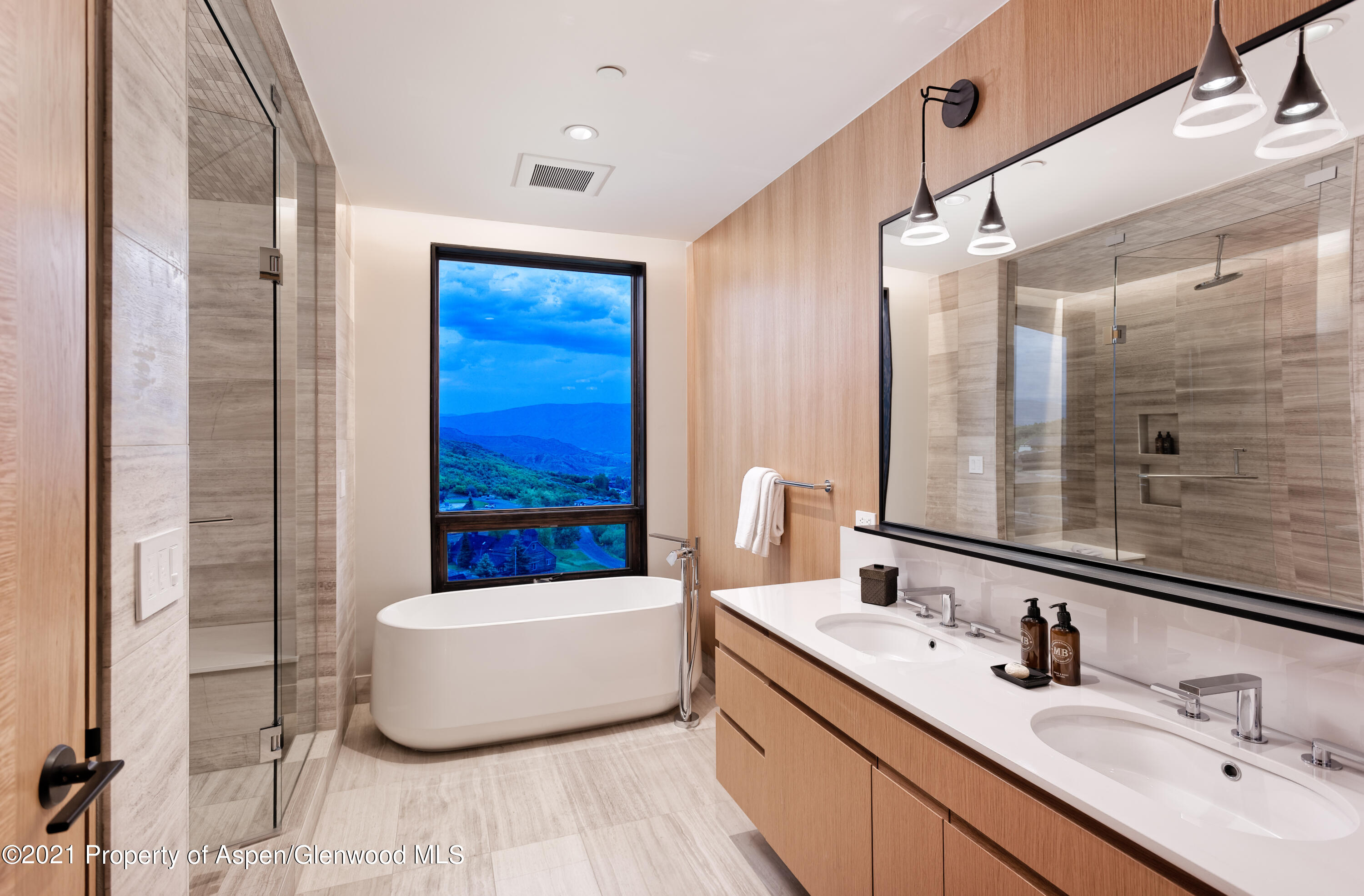 77 Wood Road, Unit 801E Snowmass Village, CO 81615 - Photo 10 of 30 a bathroom with a double vanity sink a mirror and bathtub