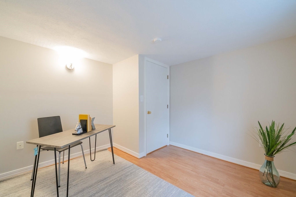 55 Sutherland Road, Unit 55 Arlington, MA 02476 - Photo 19 of 23 a workspace with furniture and wooden floor