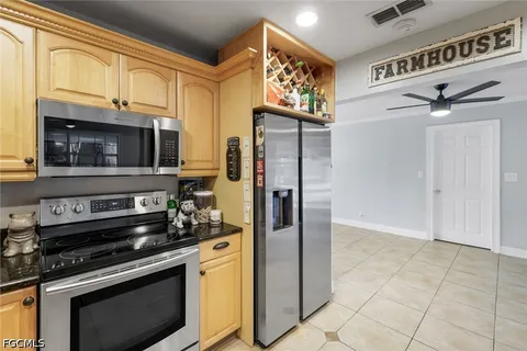 a kitchen with stainless steel appliances granite countertop a refrigerator and a stove top oven