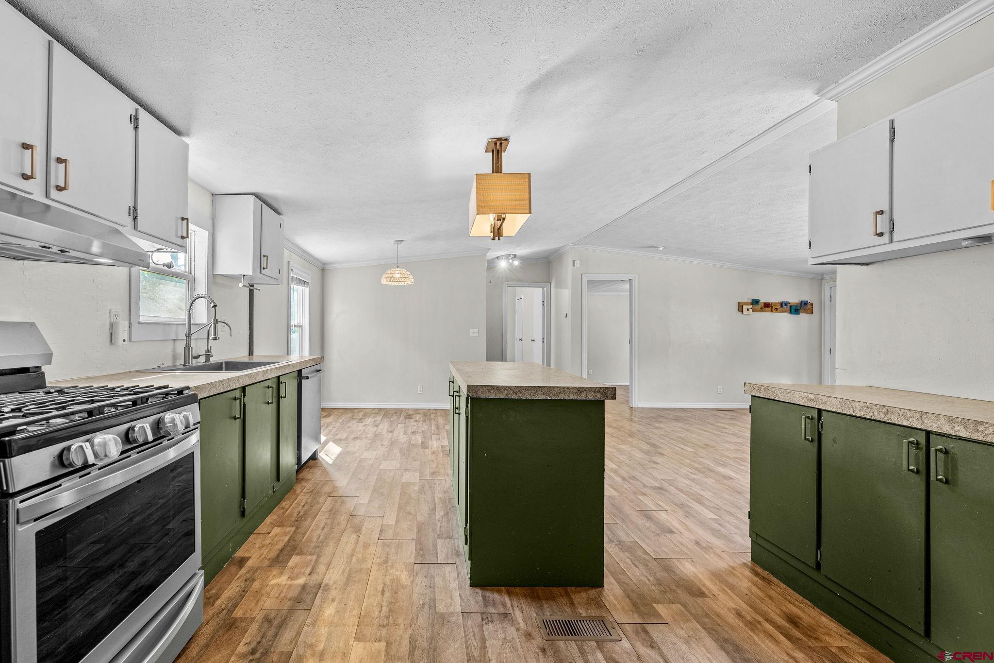 1969 County Road 142 Durango, CO 81303 - Photo 15 of 30 a kitchen with granite countertop a stove top oven and sink