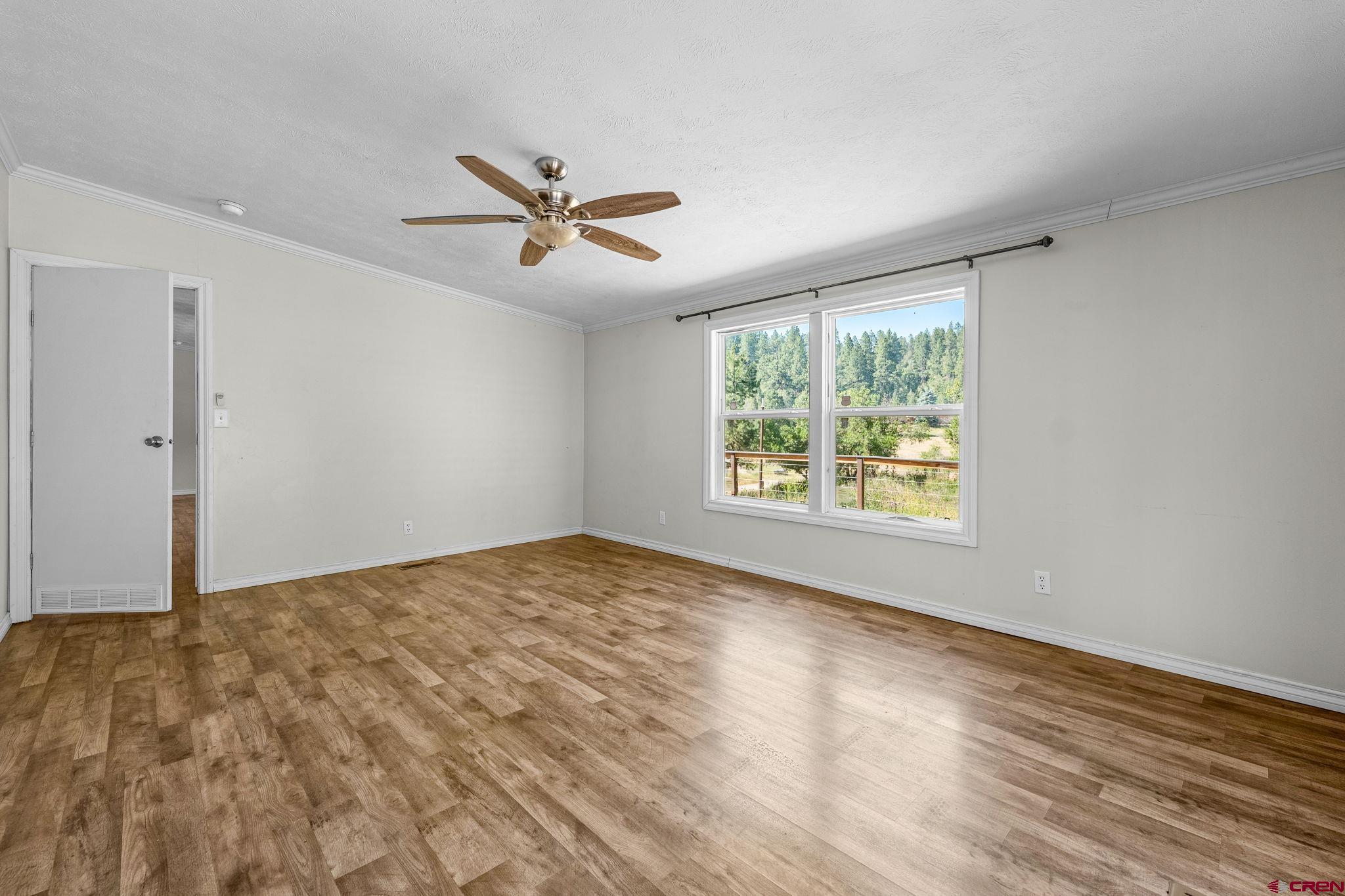1969 County Road 142 Durango, CO 81303 - Photo 18 of 30 a view of empty room with wooden floor and fan