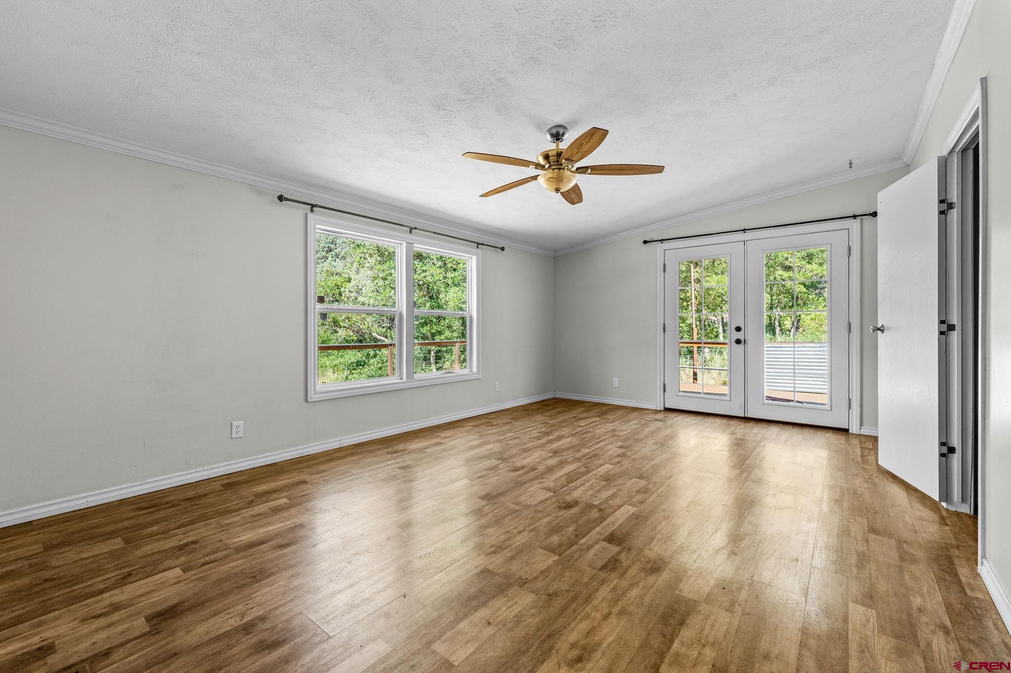 1969 County Road 142 Durango, CO 81303 - Photo 19 of 30 a view of empty room with wooden floor and fan