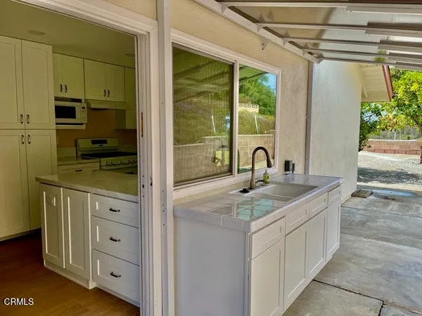 a view of cabinets a sink and a window