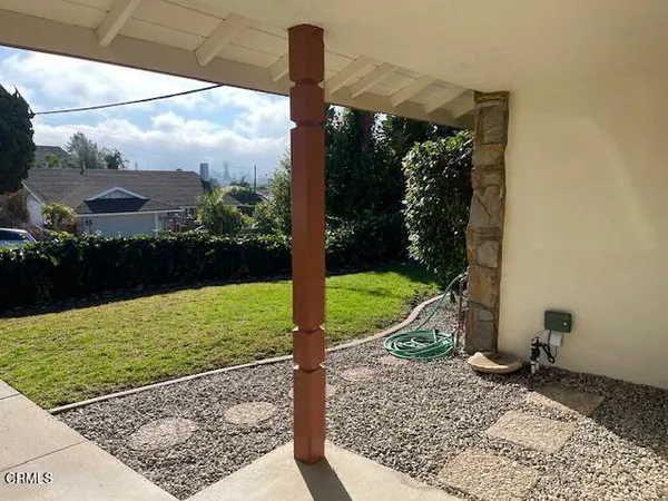 a view of a porch with a floor to ceiling window and yard