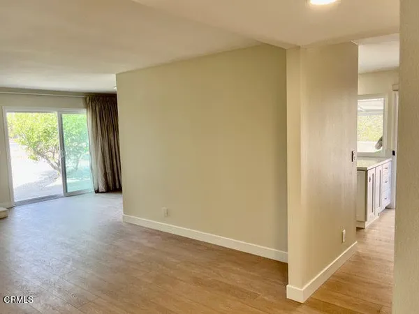 an empty room with wooden floor and a window