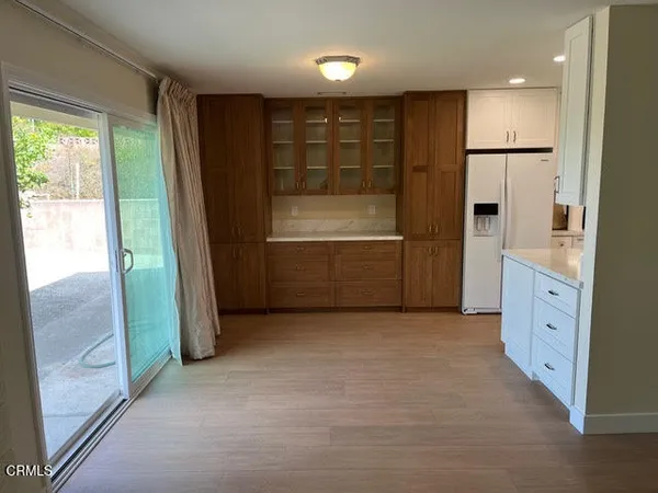 an empty room with a cabinet and mirrors