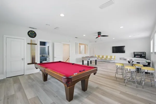 a room with pool table and flat screen tv