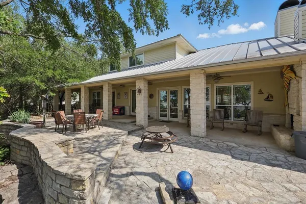 a view of a house with backyard outdoor seating area and furniture