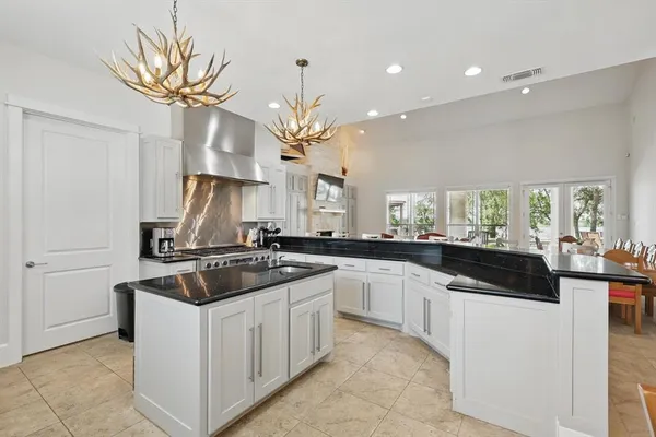 a kitchen with a sink a stove and cabinets