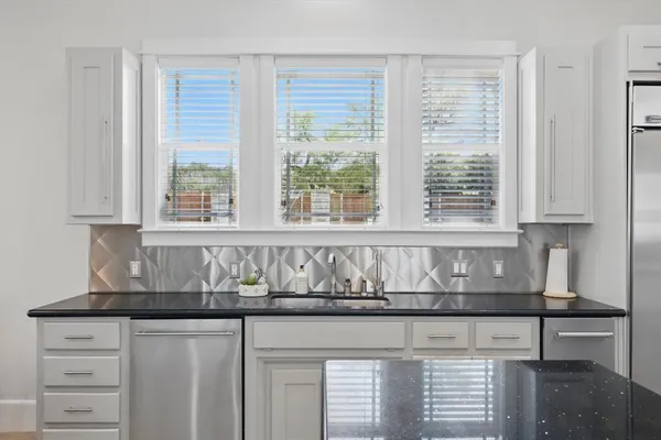 a kitchen with granite countertop a sink and a window