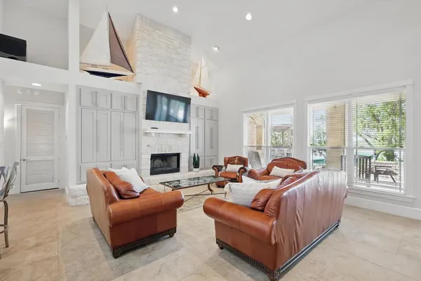 a living room with furniture large window and a fireplace