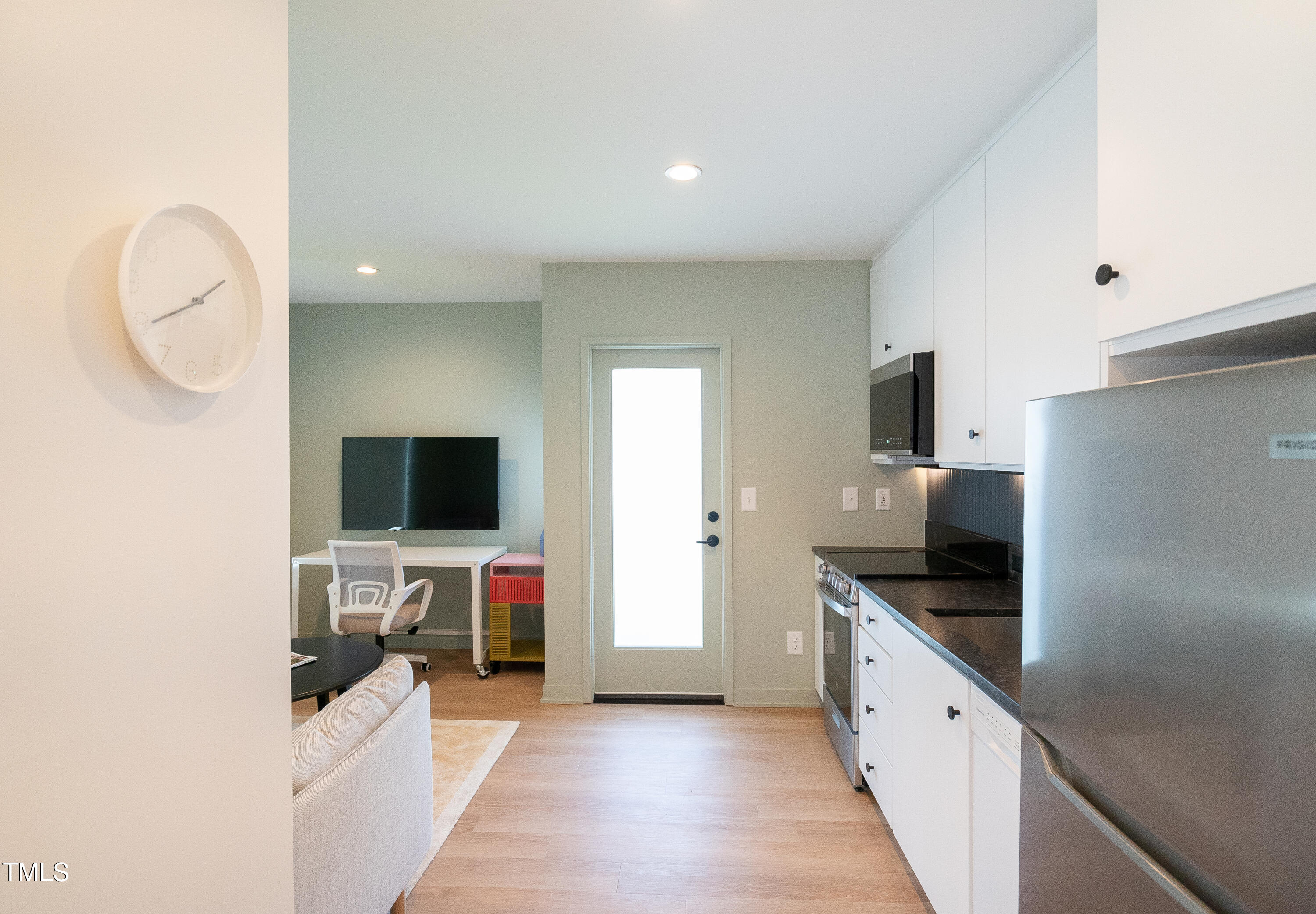 901 East Edenton Street, Unit 1 Raleigh, NC 27601 - Photo 16 of 17 a kitchen with sink a microwave and cabinets