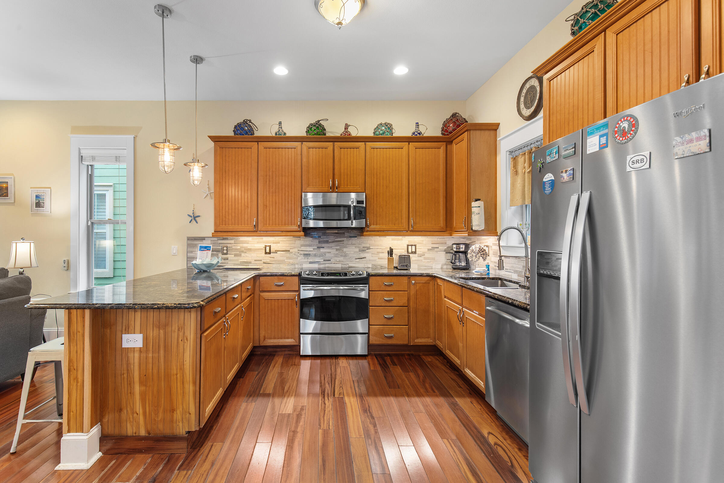 44 Asher Way Santa Rosa Beach, FL 32459 - Photo 21 of 63 a kitchen with stainless steel appliances granite countertop a refrigerator a sink dishwasher a stove and white countertops with wooden floor