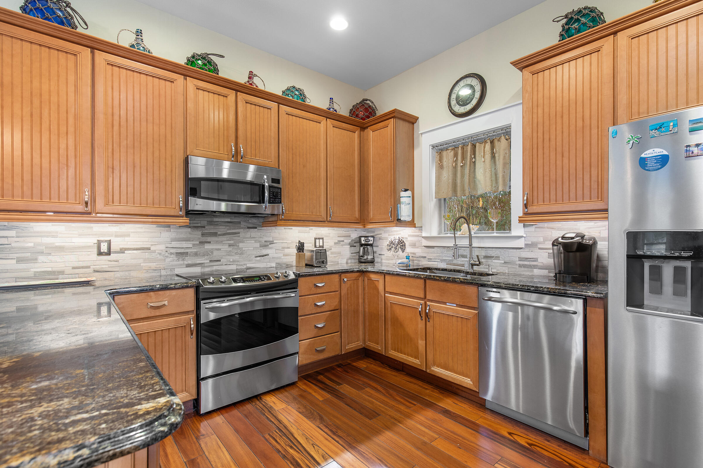 44 Asher Way Santa Rosa Beach, FL 32459 - Photo 28 of 63 a kitchen with stainless steel appliances granite countertop a stove a sink and a microwave