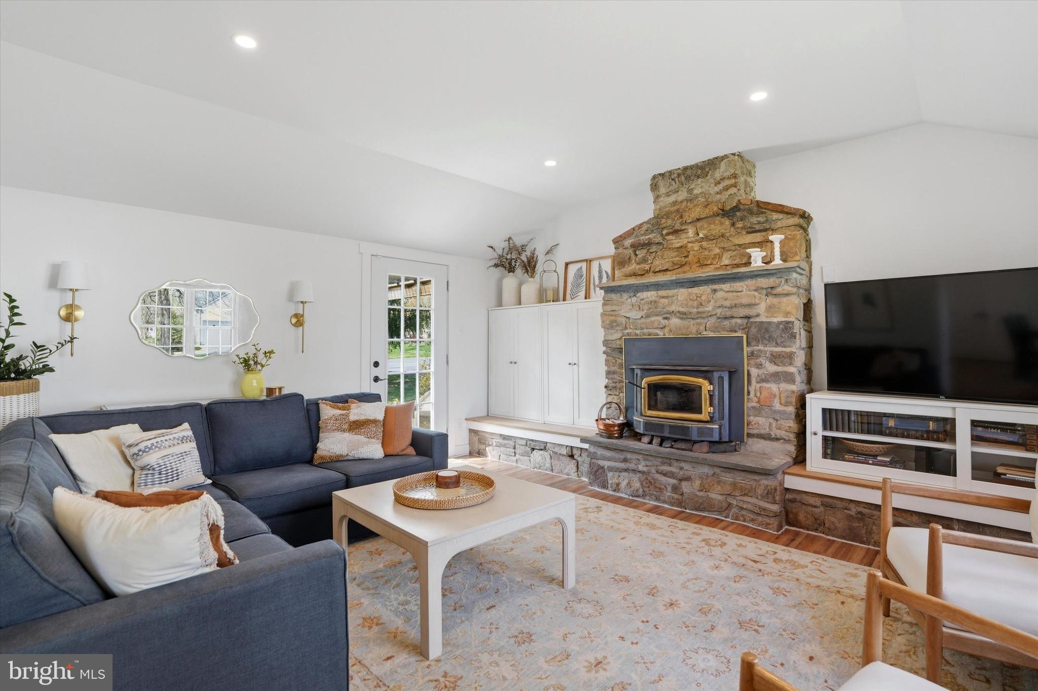 206 Gumbes Road Collegeville, PA 19426 - Photo 14 of 32 a living room with furniture a flat screen tv and a fireplace