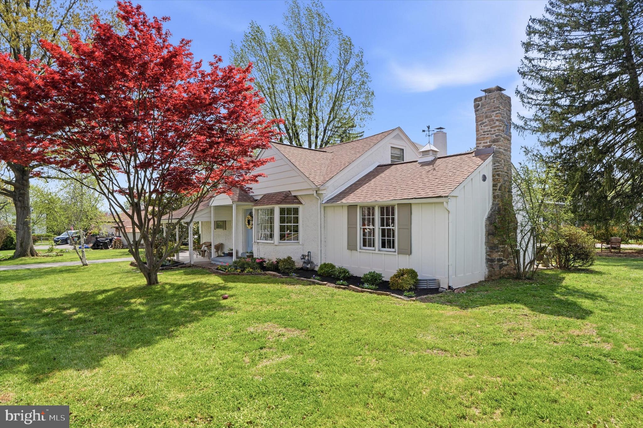 206 Gumbes Road Collegeville, PA 19426 - Photo 4 of 32 a view of a white house next to a yard with big trees