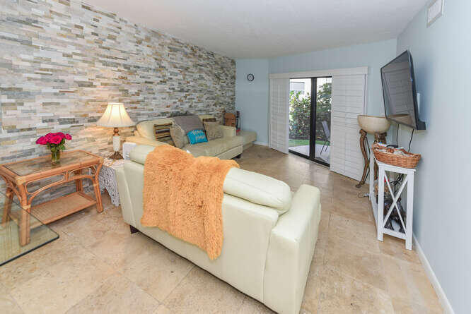 420 Celestial Way, Unit 101 Juno Beach, FL 33408 - Photo 17 of 37 a living room with furniture and a flat screen tv