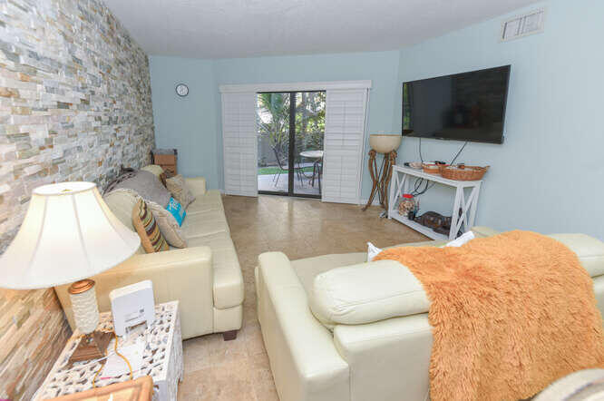 420 Celestial Way, Unit 101 Juno Beach, FL 33408 - Photo 18 of 37 a living room with furniture and a flat screen tv