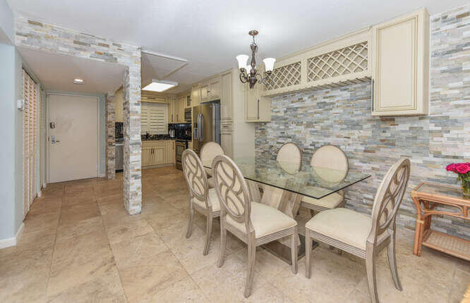 420 Celestial Way, Unit 101 Juno Beach, FL 33408 - Photo 20 of 37 a view of a dining room with furniture and a chandelier