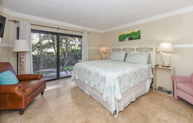 420 Celestial Way, Unit 101 Juno Beach, FL 33408 - Photo 21 of 37 a bedroom with a bed and a couch next to a window