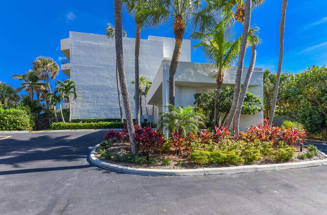 420 Celestial Way, Unit 101 Juno Beach, FL 33408 - Photo 9 of 37 front view of a house with a yard and potted plants