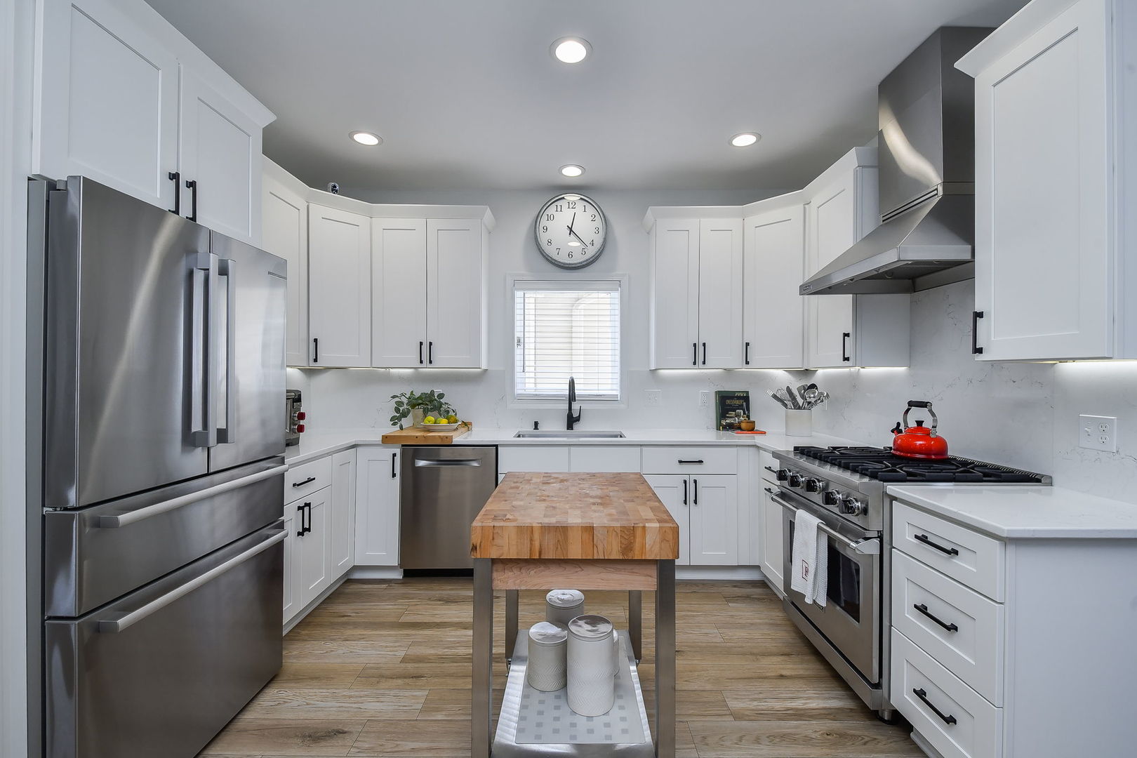 39W232 Armstrong Lane Geneva, IL 60134 - Photo 7 of 20 a kitchen with stainless steel appliances granite countertop a refrigerator a sink dishwasher a stove and white cabinets with wooden floor