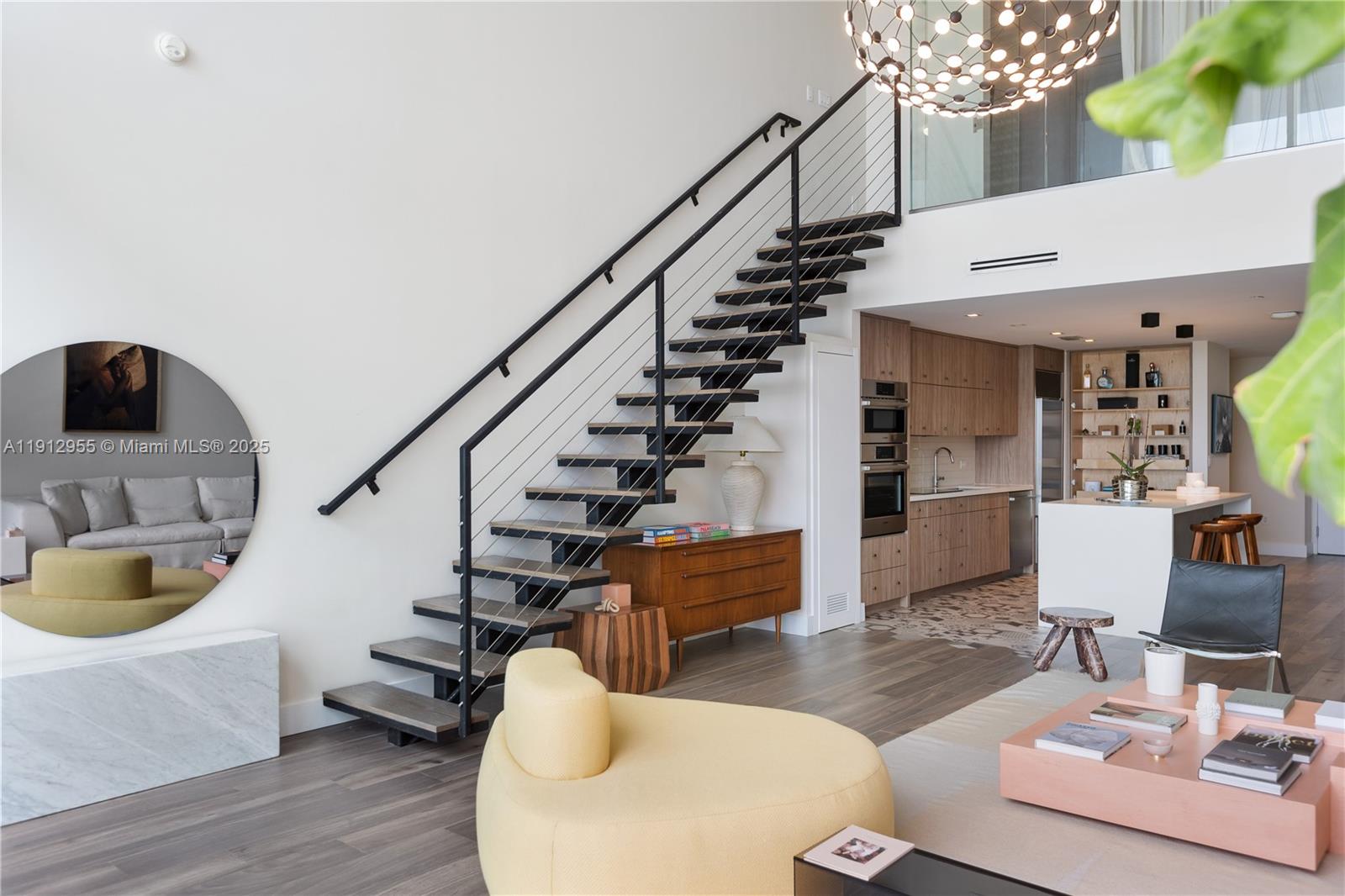 1040 Biscayne Boulevard, Unit 1602 Miami, FL 33132 - Photo 12 of 39 a living room with furniture and a chandelier
