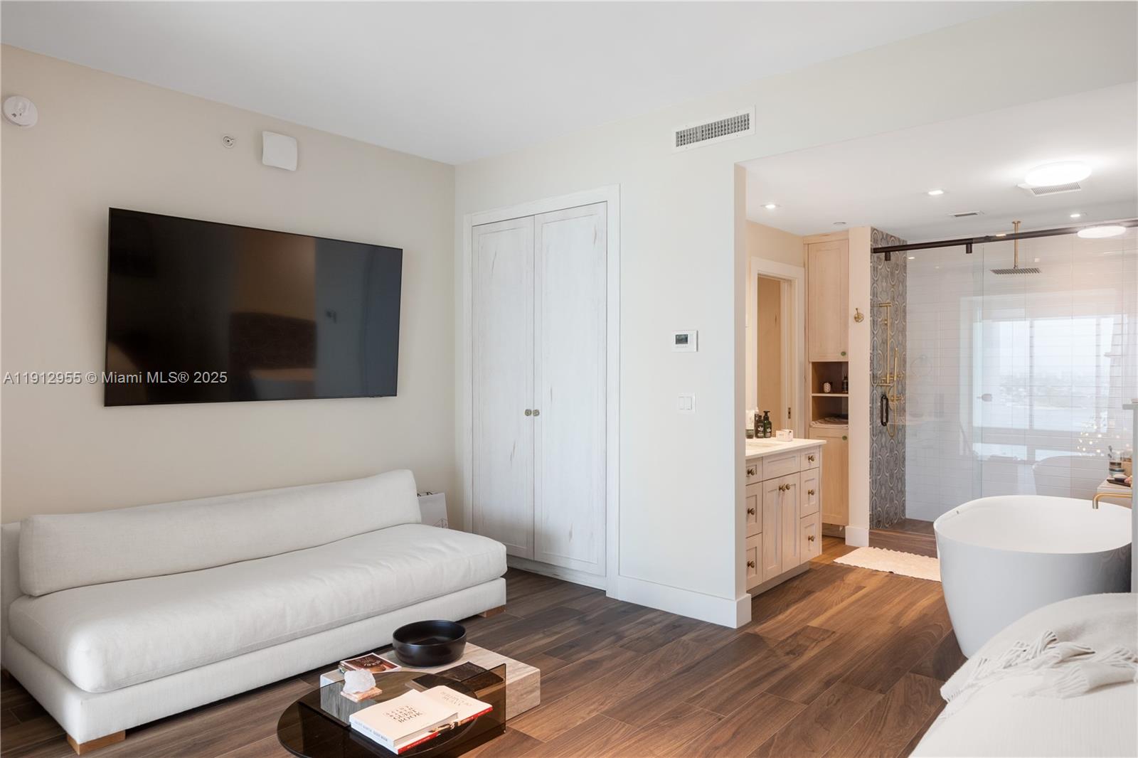 1040 Biscayne Boulevard, Unit 1602 Miami, FL 33132 - Photo 19 of 39 a living room with furniture and a flat screen tv