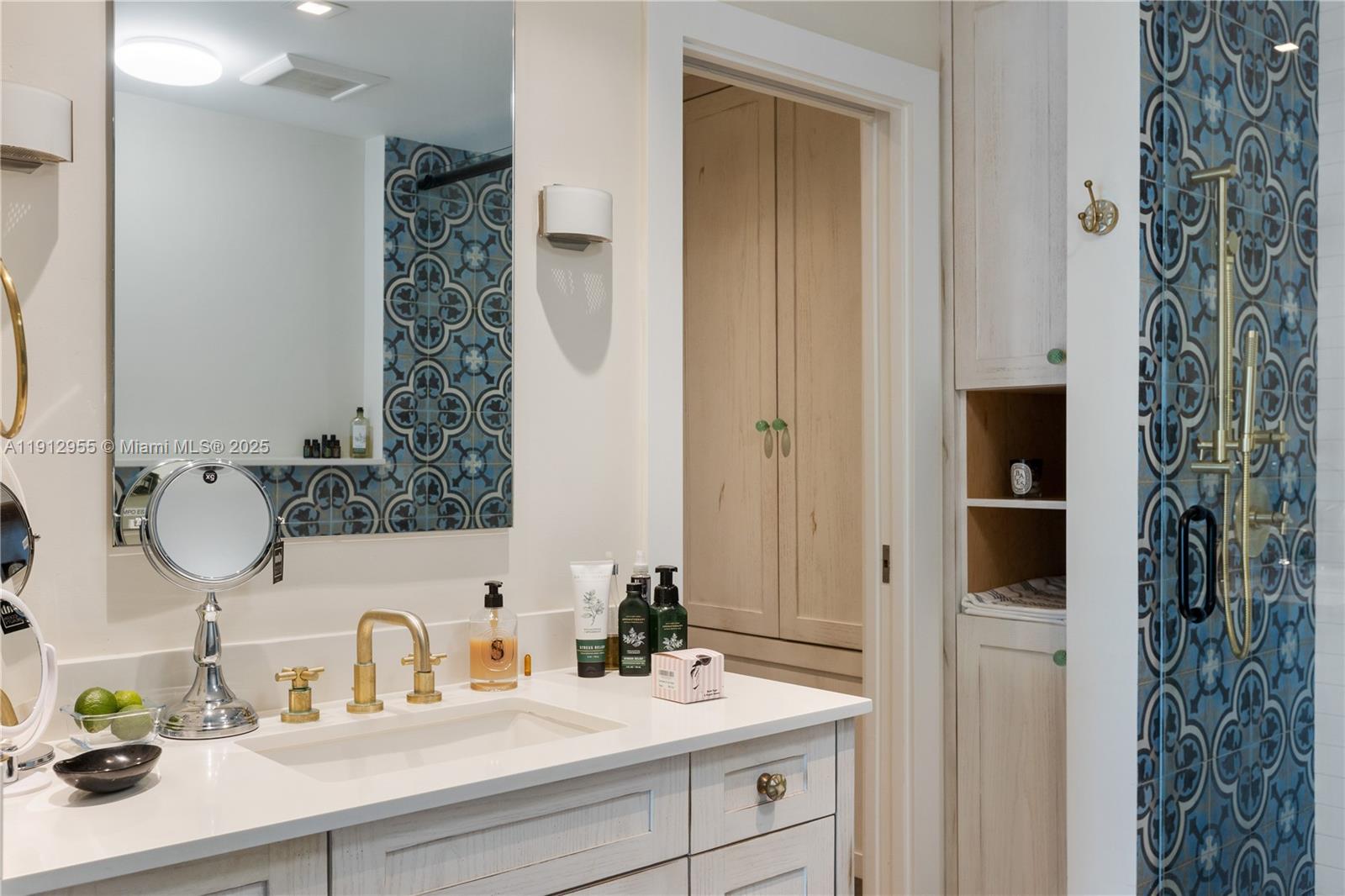 1040 Biscayne Boulevard, Unit 1602 Miami, FL 33132 - Photo 22 of 39 a bathroom with a sink and a mirror