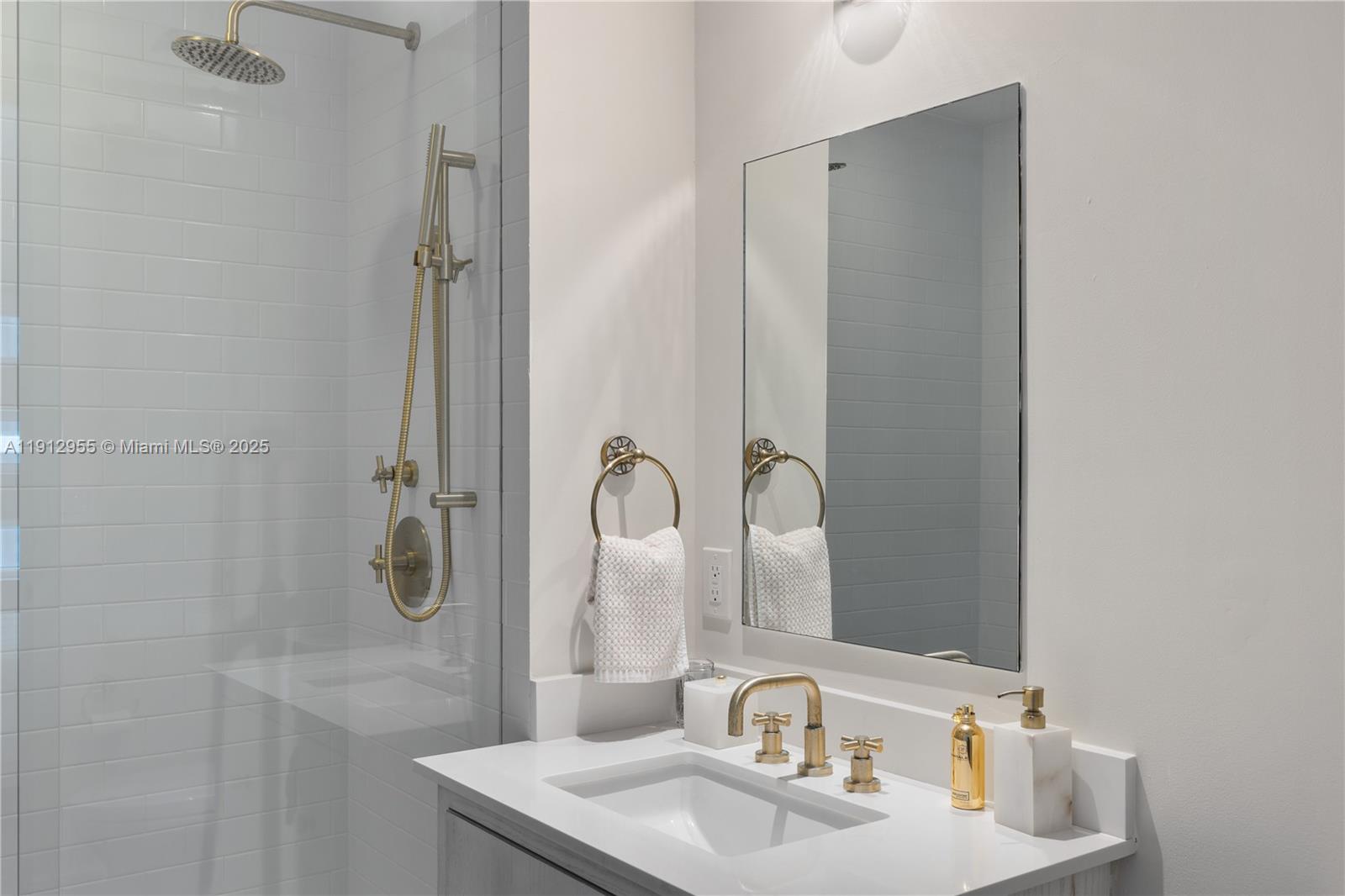 1040 Biscayne Boulevard, Unit 1602 Miami, FL 33132 - Photo 23 of 39 a bathroom with a sink and a mirror