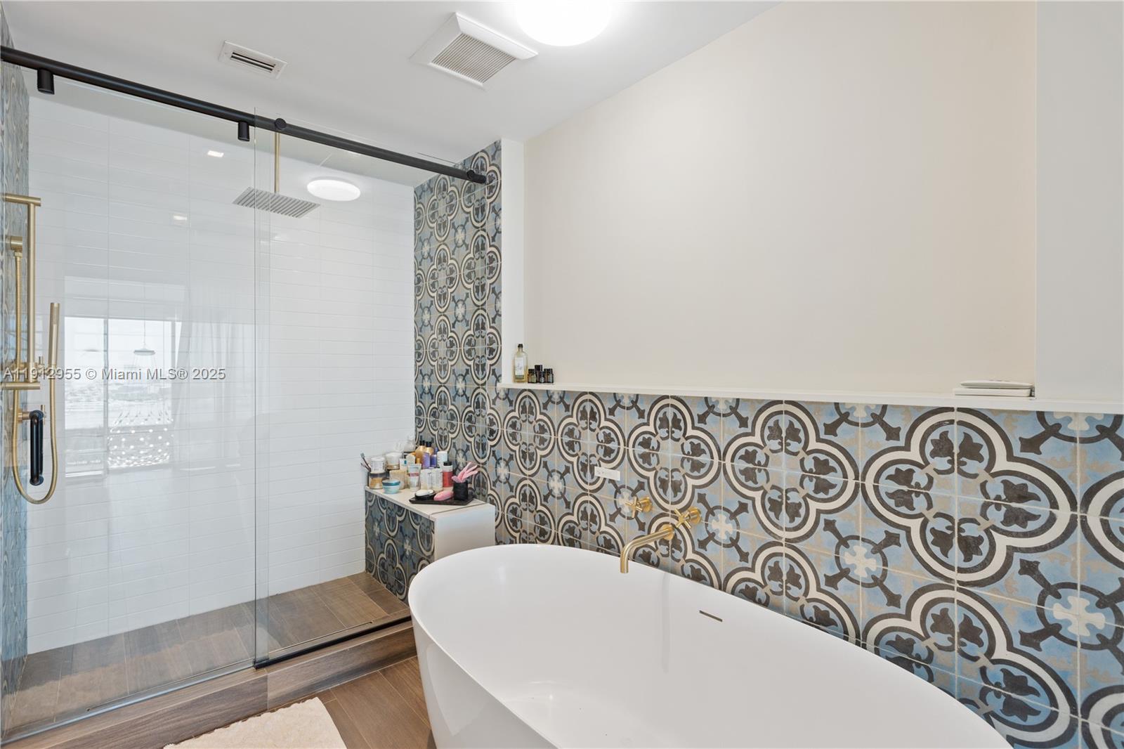 1040 Biscayne Boulevard, Unit 1602 Miami, FL 33132 - Photo 24 of 39 a bathroom with a bathtub and shower