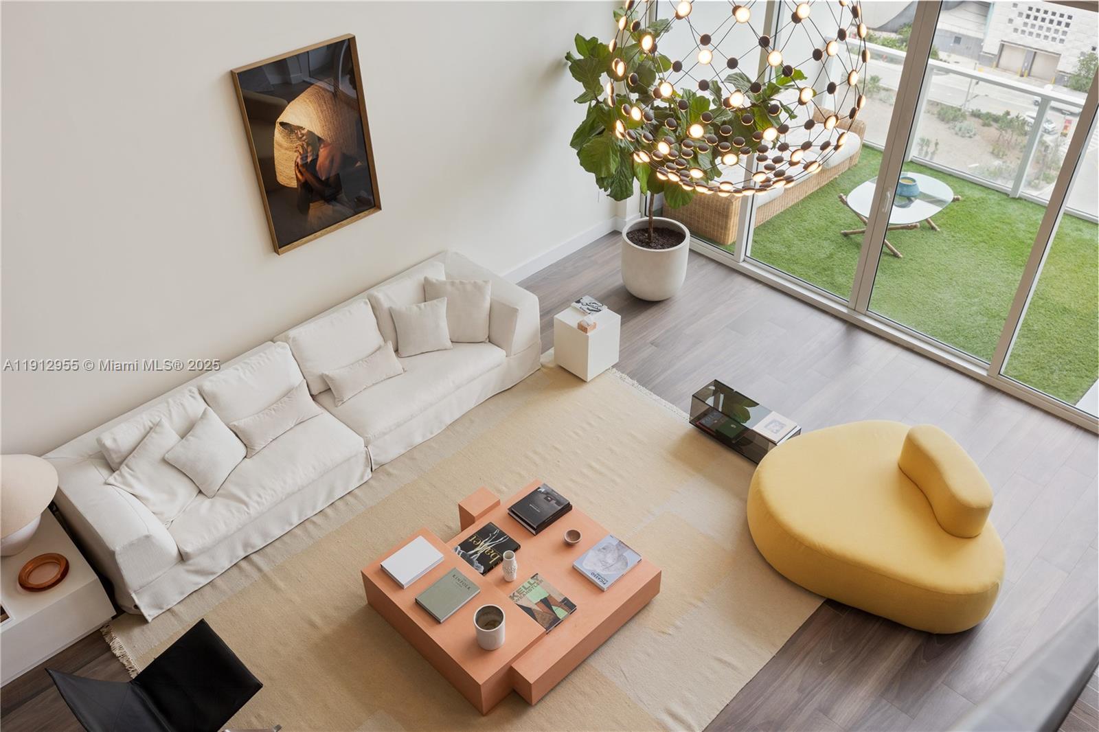 1040 Biscayne Boulevard, Unit 1602 Miami, FL 33132 - Photo 25 of 39 a living room with furniture and a chandelier