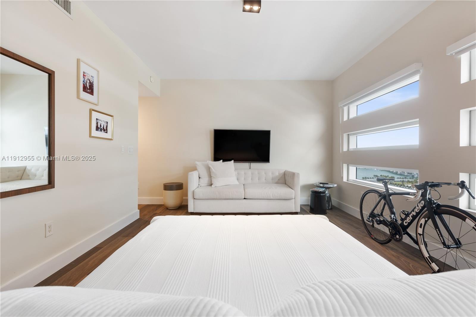 1040 Biscayne Boulevard, Unit 1602 Miami, FL 33132 - Photo 27 of 39 a bedroom with a bed and a flat screen tv