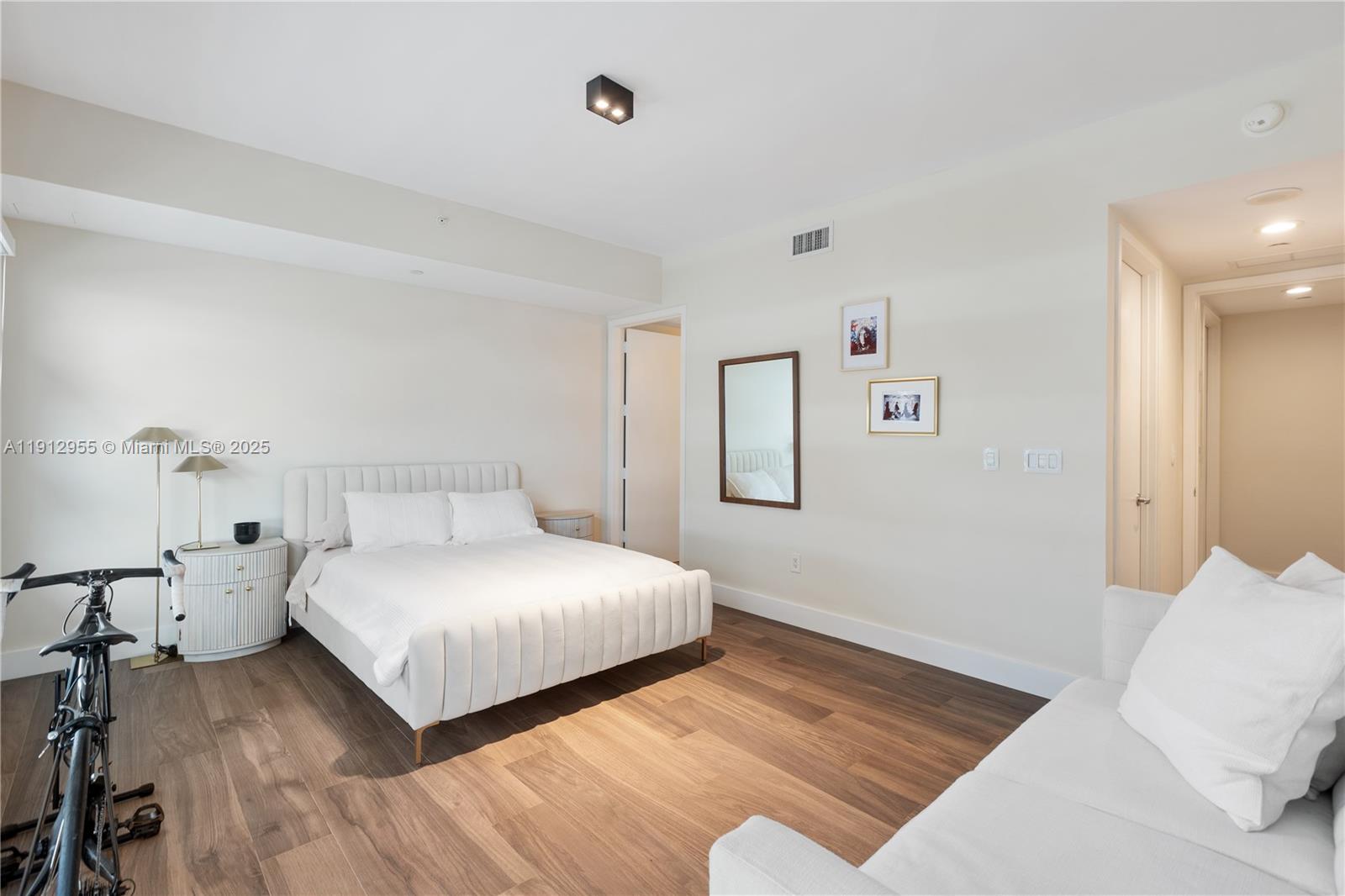 1040 Biscayne Boulevard, Unit 1602 Miami, FL 33132 - Photo 28 of 39 a bedroom with a bed and a night stand