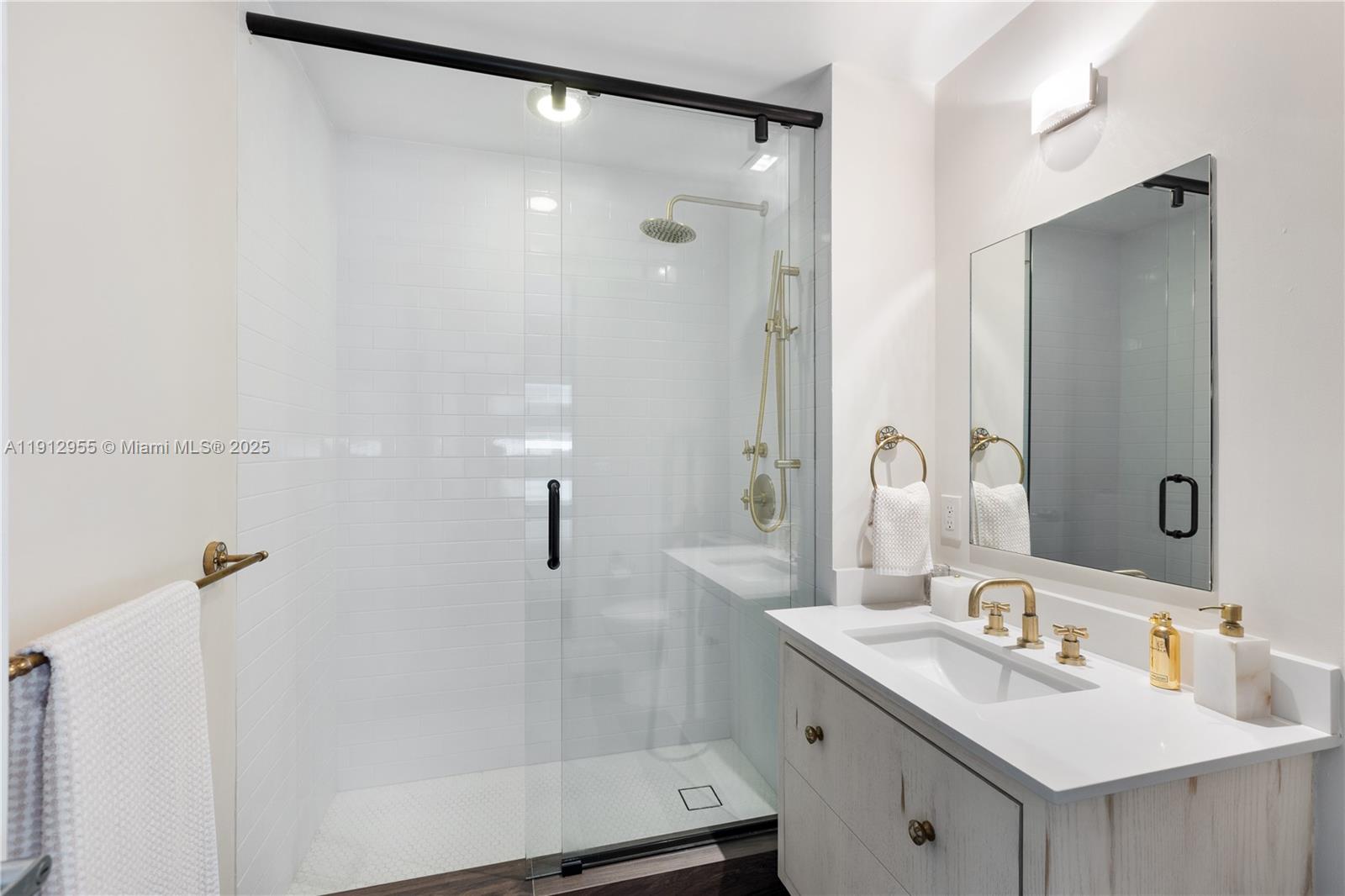1040 Biscayne Boulevard, Unit 1602 Miami, FL 33132 - Photo 29 of 39 a bathroom with a sink mirror and shower