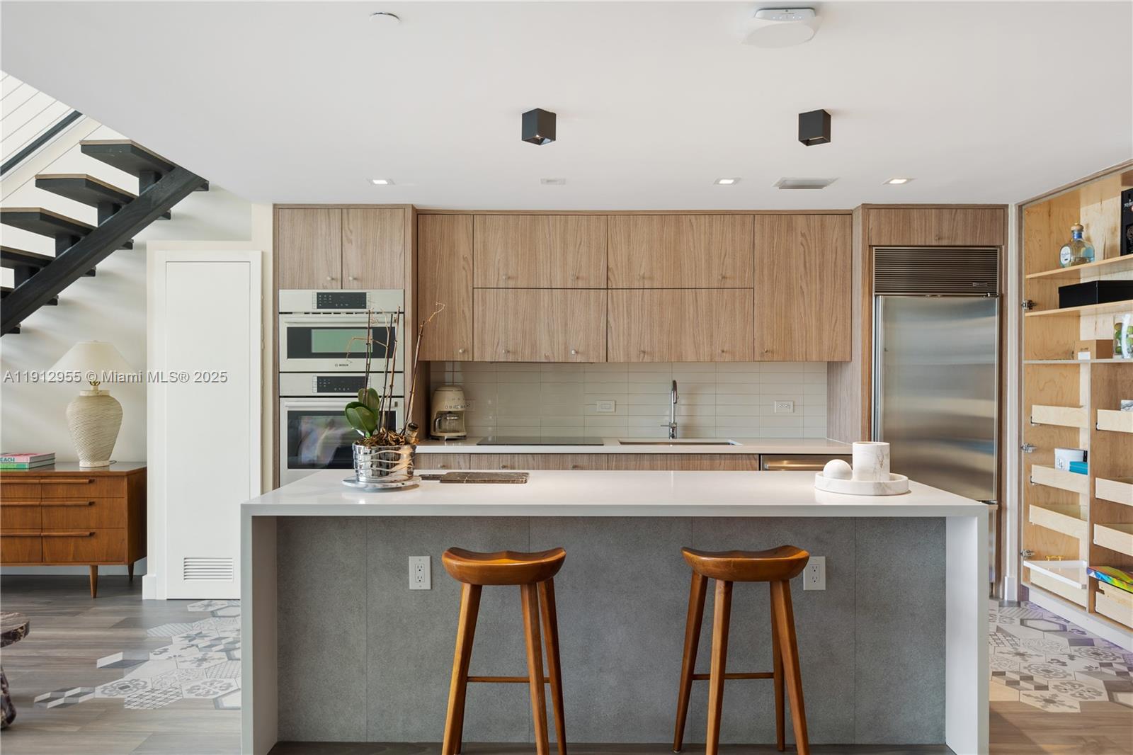 1040 Biscayne Boulevard, Unit 1602 Miami, FL 33132 - Photo 3 of 39 a kitchen with stainless steel appliances granite countertop a sink and a refrigerator