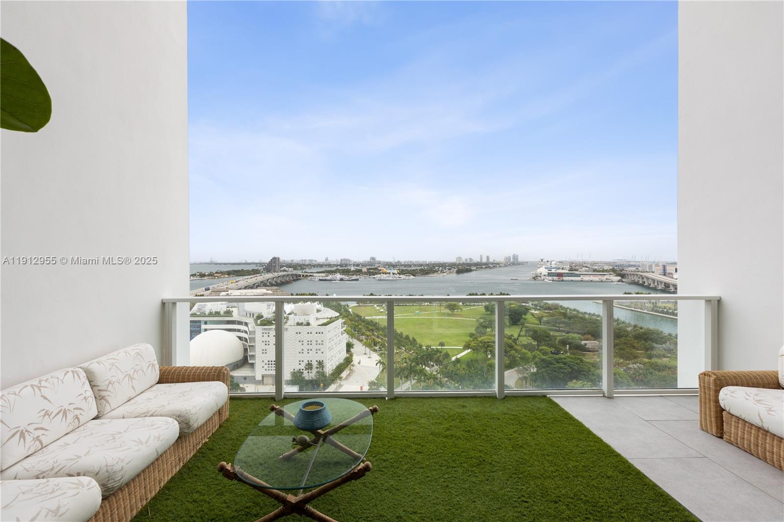 1040 Biscayne Boulevard, Unit 1602 Miami, FL 33132 - Photo 33 of 39 a view of a swimming pool and couches in the patio